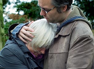 Man comforting a woman in a crisis